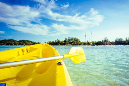 Paddling yellow kayak into the Andaman sea,  kayaks at tropical ocean during summer vacationの写真素材
