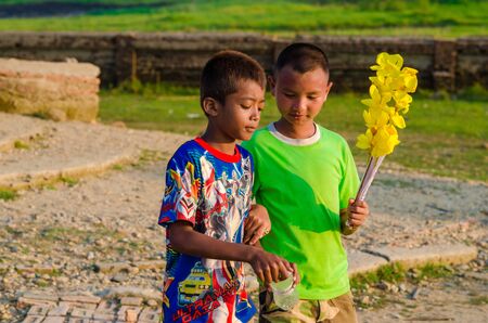 Sangkhlaburi, Thailand - May 4, 2014: Unidentified young asian Mon boy enjoying with friends at Old temple in Sangkhlaburi,Thailand.のeditorial素材