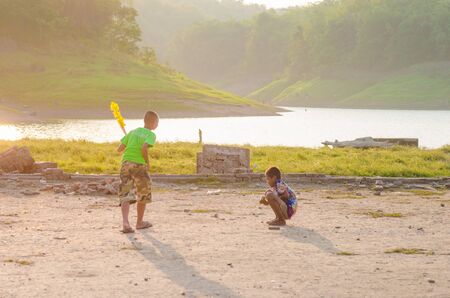 Sangkhlaburi, Thailand - May 4, 2014: Unidentified young asian Mon boy enjoying with friends at Old temple in Sangkhlaburi,Thailand.のeditorial素材