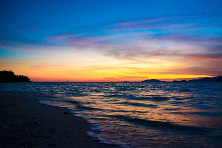 Andaman sea sunset background on the sky, Tropical sunset on the beach.の写真素材
