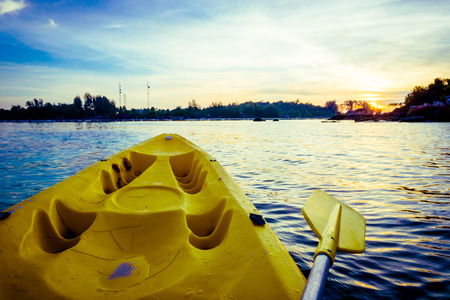 Kayaking at the tropical beach with beautiful sunset, Yellow kayakの写真素材