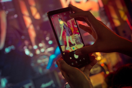 People use smartphone take picture at a concert, Crown of people enjoy