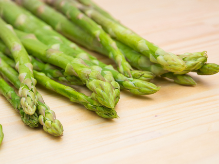 Fresh asparagus on wooden table, closeup with macro lenの写真素材