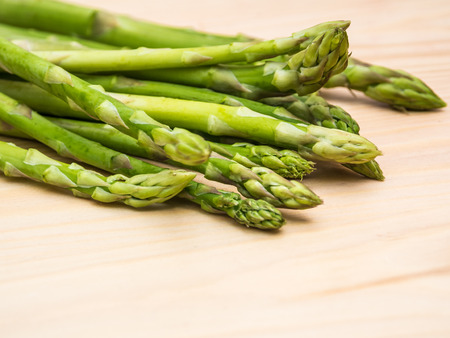 Bunch of Green Vegetable fresh green asparagus spears on a rustic wooden tableの写真素材