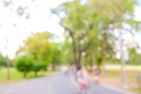 Blurred green background of people activities in park running and bicycleの写真素材