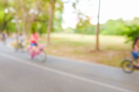 Blurred green background of people activities in park running and bicycleの写真素材