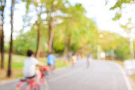 Blurred green background of people activities in park running and bicycleの写真素材
