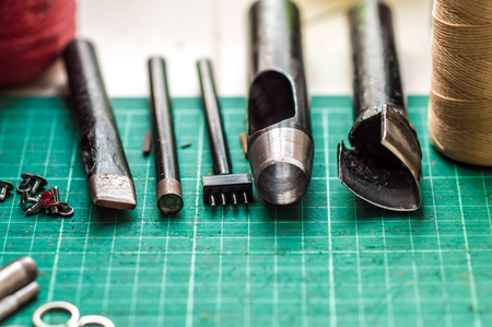 Working space background with leather camera strap using crafting DIY toolsの写真素材