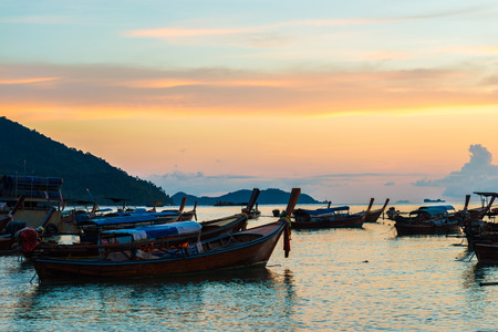 Fishing boat on beach silhouette in sunset light colourful cloudのeditorial素材
