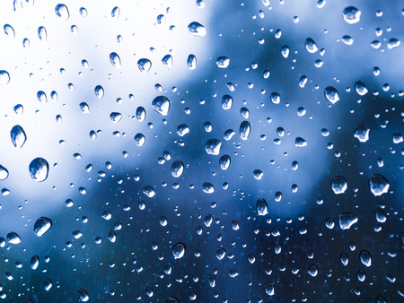 Close up water drops on blue background rainyの写真素材