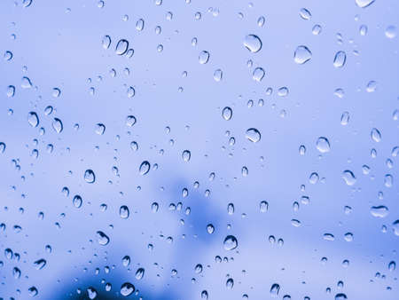 Close up water drops on blue background rainyの写真素材