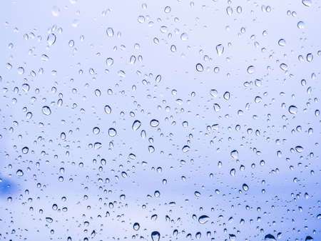 Close up water drops on blue background rainyの写真素材