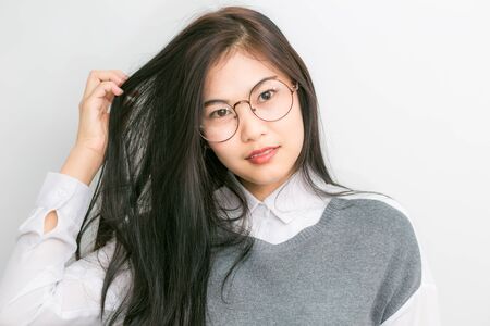 Portrait young asian nerd business woman with hipster glasses close up on white backgroundの写真素材