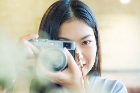 Woman taking photo in coffee shop smiling asian womenの写真素材