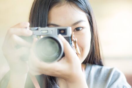 Woman taking photo in coffee shop smiling asian womenの写真素材