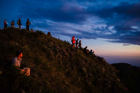 Group of tracking tourist silhouette on the mountain sunset. Sport and active lifeの写真素材