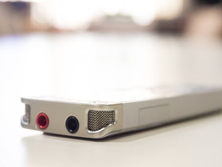 Dictaphone on white table while business meeting close up