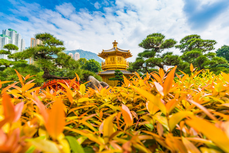 Golden Pavilion of Absolute Perfection in the Nan Lian Garden with tree blue sky, Hong Kong.の写真素材