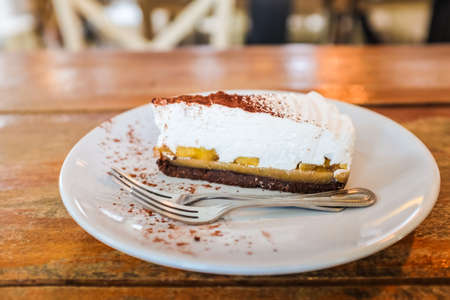 Cake topping with dark chocolate in dish on wood tableの写真素材