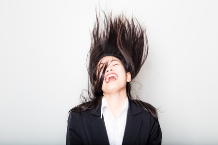 Professional young beautiful female office model feel free in white dress black suit on white backgroundの写真素材