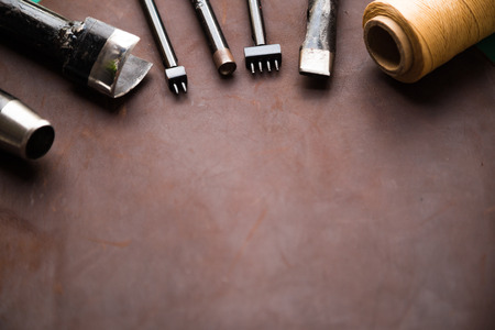 Top flat lay view of craftsman ship tool work space to skin leather productsの写真素材