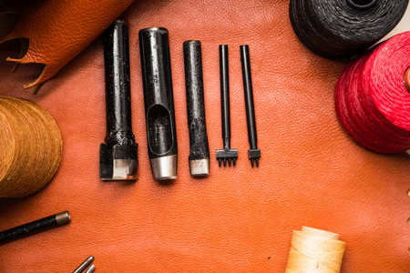 Flat lay of Leather crafting tool on skin product of genuine leather