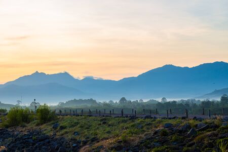 Mountain sunrise silhouette scene in reservoir background with mountain, Natural landscapeの写真素材