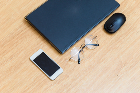 Flat lay object laptop with glasses and cellphone on old wooden tableの写真素材