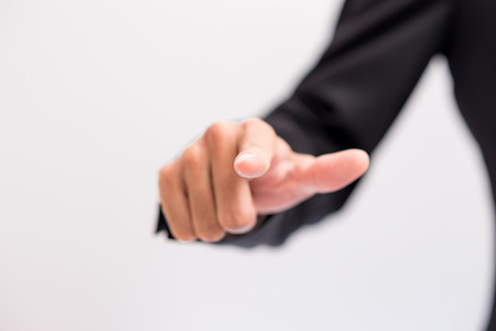 Business asian man in suit show finger hand on white backgroundの写真素材