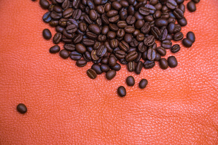 Closeup of coffee beans on leather backgroundの写真素材