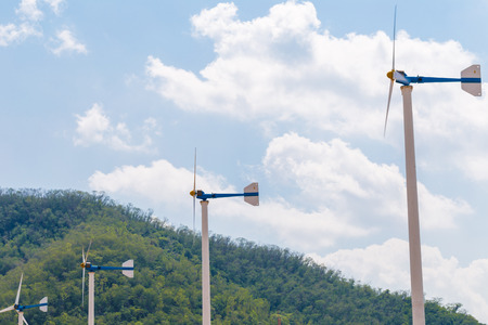 Green mountain with park of wind turbines generating electricity
