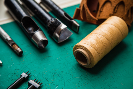 Background of leather craftsmanship with tool for handmade productの写真素材