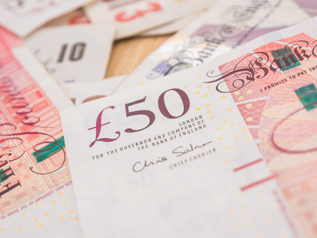 Blurred pound note background money, Dept of field saving conceptの写真素材