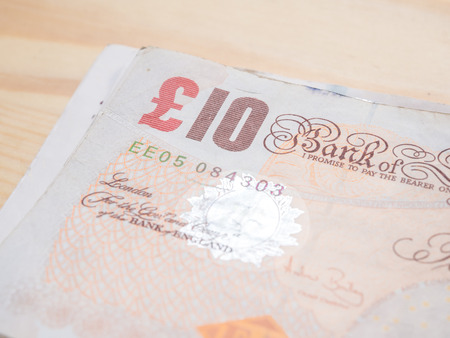 Blurred pound note background money, Dept of field saving conceptの写真素材