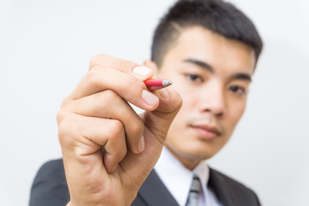 Hand of business asian man write on white background selective focusの写真素材