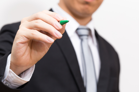 Hand of business man write pen on white backgroundの写真素材