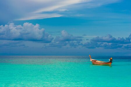 Boat with sea and sky background vacation time, Wooden local boat on seaの写真素材