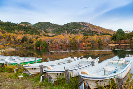 Fishing boat park on lake in evening autumn mountain at Nikko, Tobu, Japanのeditorial素材