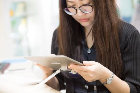 Asian business office women use tablet computer in libraryのeditorial素材
