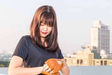 Asian woman fitness sunrise stretch before jogging workout wellness concept building background.のeditorial素材
