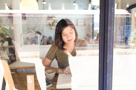 Women reading book in art loft cafe, Education conceptの写真素材
