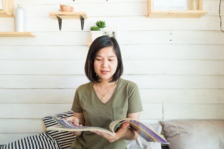 Women reading book in art loft cafe, Education conceptの写真素材