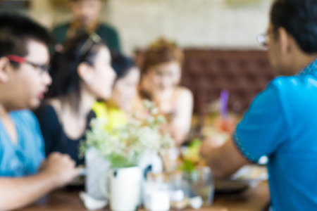 Blurred background people sitting in art loft cafe, Defocused crowd in coffee shopの写真素材