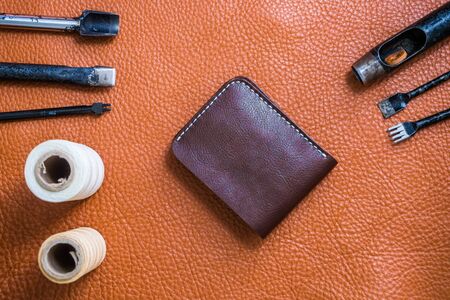 Genuine leather with craftsmanship tool for make wallet on leather backgroundの写真素材
