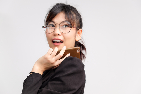 Young office women talking mobile phone on white backgroundの写真素材