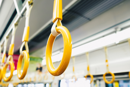 Yellow handrail holding bar inside of subway, Train transportの写真素材