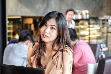 Young smart freelance business women use laptop in coffee shop thinking for work ideaの写真素材