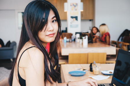 Casual business women intend to use laptop computer in modern cafe, Communication conceptの写真素材