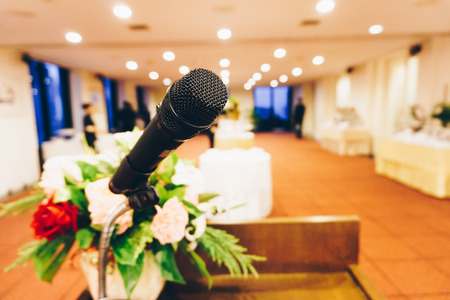Microphone close up in seminar conference room abstract blurred backgoundの写真素材