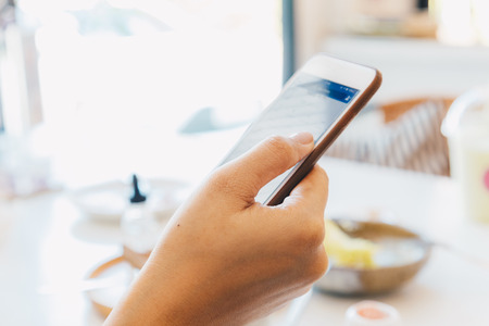 Smartphone on women hand in cafe for communicationの写真素材